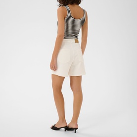 Model wearing Kaffe chalk shorts, styled with a black and white striped crop top and black kitten heel mules, rear view.