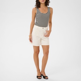 Model wearing Kaffe chalk shorts with black and white striped tank top and black mule heels