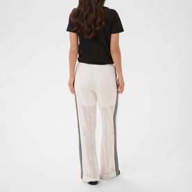 Model wearing Kaffe chalk wide-leg trousers with contrast side stripe, styled with a black T-shirt, rear view.