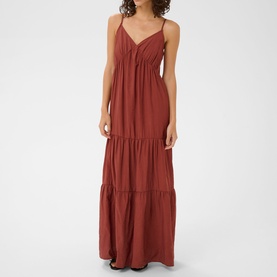 Model wearing Kaffe henna maxi dress with V-neckline, spaghetti straps, and tiered skirt in crinkle fabric