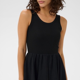 Model wearing Kaffe black deep sleeveless dress with fitted ribbed bodice and flared skirt