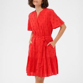 Model wearing Kaffe Poppy Red tiered wrap dress with short flutter sleeves, self-tie belt, and side pockets