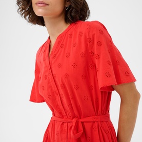 Model wearing Kaffe Poppy Red broderie anglaise wrap dress with flutter sleeves and tie waist