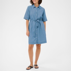 Model wearing Kaffe medium blue chambray shirt dress with tie waist and short sleeves, styled with black flat sandals