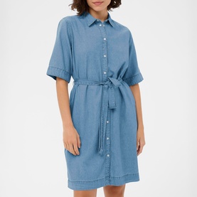 Model wearing Kaffe medium blue chambray shirt dress with short sleeves, button front, and self-tie waist belt, knee length