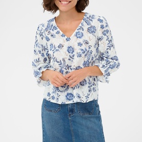 Model wearing Kaffe blouse in Chalk Midnight Flower, blue floral print, V-neck, 3/4 sleeves, styled with blue denim jeans.