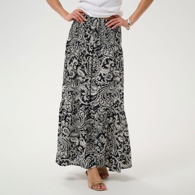 Model wearing Kaffe Black Chalk Paisley maxi skirt with tiered hem, styled with a white top and nude sandals.