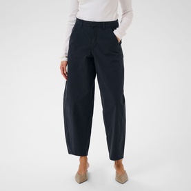 Model wearing Kaffe Midnight Marine wide-leg tapered trousers, styled with a white top and grey mules