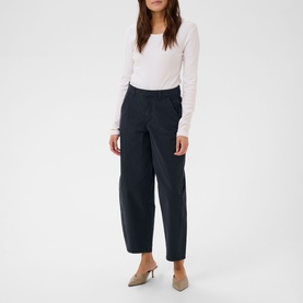 Model wearing Kaffe Midnight Marine wide-leg trousers with a white long-sleeve top and nude slingback heels.