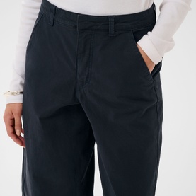 Model wearing Kaffe Midnight Marine wide-leg trousers with front pockets, styled with a white long-sleeve top and silver bracelet.