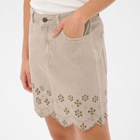 Model wearing Kaffe Feather Gray denim mini skirt with scalloped hem, floral eyelet embroidery, and front pocket detail