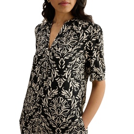 Model wearing Hobbs black and cream floral print short-sleeve dress with V-neckline and botanical pattern