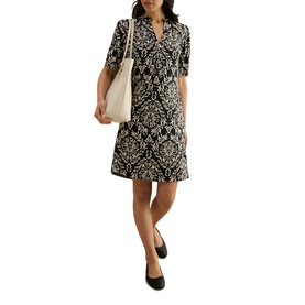 Model wearing Hobbs black and cream damask print wrap dress, styled with a cream tote bag and black flat shoes
