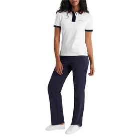 Model wearing Calvin Klein Golf white polo shirt with navy tipping, paired with navy straight-leg trousers and white trainers.