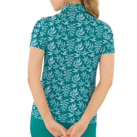Model wearing Pure Golf women's teal short-sleeve polo shirt with all-over leaf print, shot from behind.