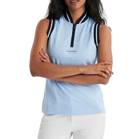 Model wearing Calvin Klein Golf sleeveless polo shirt in Blue Bell with polka dot print, navy trim collar and zip, arms crossed.