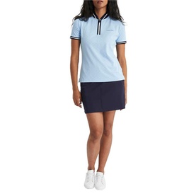 Model wearing Calvin Klein Golf Blue Bell polo shirt with navy tipping detail, styled with navy mini skirt and white trainers.