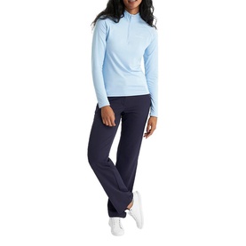 Model wearing Calvin Klein Golf Blue Bell quarter-zip long-sleeve top with navy wide-leg trousers and white trainers.