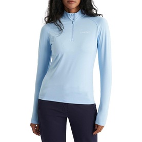 Model wearing Calvin Klein Golf Blue Bell half-zip long sleeve top with thumbhole cuffs, styled with navy trousers.