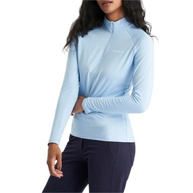 Model wearing Calvin Klein Golf Blue Bell long-sleeve quarter-zip top, styled with navy trousers.