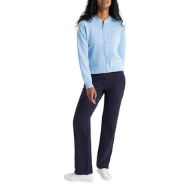 Model wearing Calvin Klein Golf Blue Bell zip-up jacket with navy wide-leg trousers and white trainers.