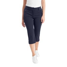 Model wearing Calvin Klein Golf navy cropped trousers with front pockets, styled with white trainers and a white top.