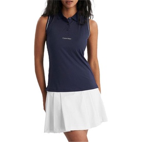 Model wearing Calvin Klein Golf navy sleeveless polo shirt with white pleated skirt and small logo detail at chest.