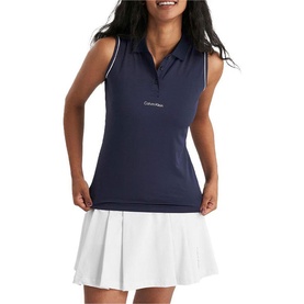 Model wearing Calvin Klein Golf navy sleeveless polo shirt with white trim collar, styled with white pleated skirt.