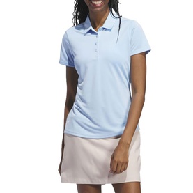Model wearing Adidas Golf womens polo shirt in Clear Sky blue, short sleeves, three-button placket, styled with light pink skirt.