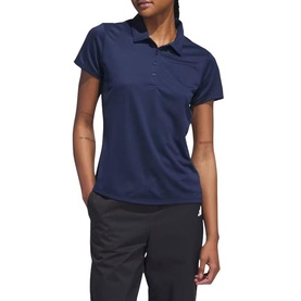 Model wearing Adidas Golf polo shirt in Collegiate Navy, short sleeves, button placket with chest pocket, styled with dark trousers.