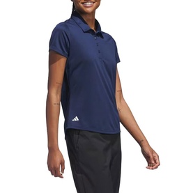 Model wearing Adidas Golf polo shirt in Collegiate Navy, short sleeve with collar, styled with black trousers