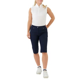 Model wearing Pure Golf navy golf shorts with white sleeveless polo top and white trainers