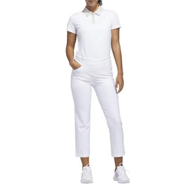 Model wearing Adidas Golf white straight-leg cropped trousers, styled with a white polo shirt and white trainers.