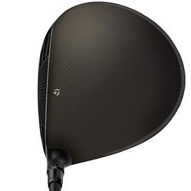 TaylorMade golf driver with dark carbon fibre crown, black finish, and branded hosel, shown from top-down angle