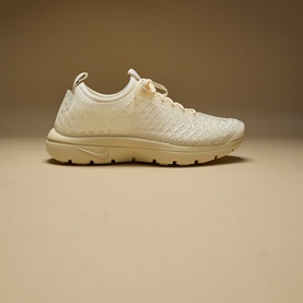 Nike trainer in Muslin and Pale Ivory, featuring woven knit upper, lace fastening, and tonal rubber sole.