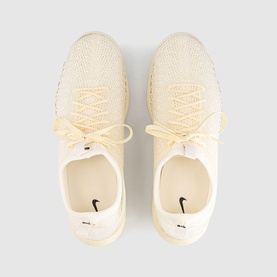 Nike trainers in muslin and pale ivory, knit upper with lace-up front, cream rubber sole, top-down pair view