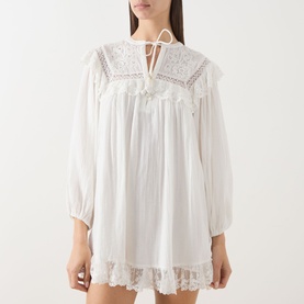 Model wearing Rixo Lilly Embroidery Ivory mini dress with lace collar, tassel tie neck, balloon sleeves and lace hem trim.