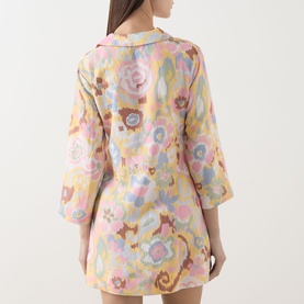 Model wearing Rixo dress in Bloom Yellow floral print, rear view, showing three-quarter sleeves and mini length