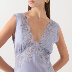 Model wearing Rixo dress in Dusty Blue, featuring deep V-neckline with delicate lace embroidery detail on bodice