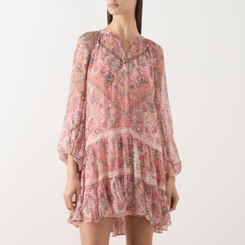 Model wearing Rixo dress in Cara Bandana Orange paisley print, long sleeves, tiered hem with lace trim detailing