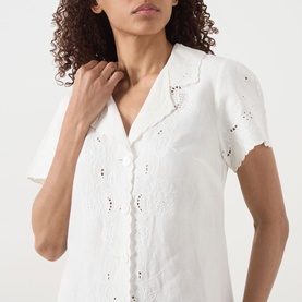Model wearing Rixo Zayanna Embroidered Mini Dress in ivory, featuring notched lapels, V-neckline, short sleeves and broderie anglaise detail