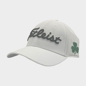 Titleist golf cap in white with black embroidered logo and green shamrock emblem, structured fit with curved brim
