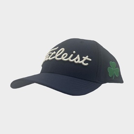 Titleist navy golf cap with embroidered white logo and green shamrock motif on side panel, structured fit with curved brim