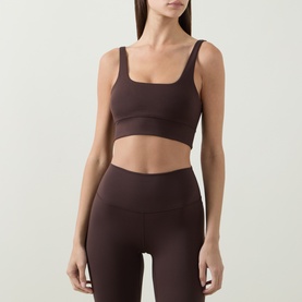 Model wearing Varley Coffee Bean Sports Bra with matching high-waist leggings. Square neckline, wide straps, cropped silhouette.