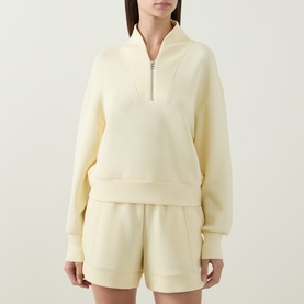 Model wearing Varley Anise Flower sweat top with half-zip collar, styled with matching shorts