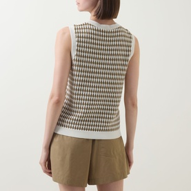 Model wearing Varley Aura Sweater Vest in Egret/Golden Olive check pattern, back view, styled with khaki shorts.