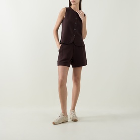 Model wearing Varley Coffee Bean sleeveless button-front vest top, styled with matching shorts and cream trainers.