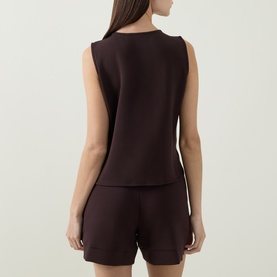 Model wearing Varley Coffee Bean sleeveless top, back view, styled with matching shorts.