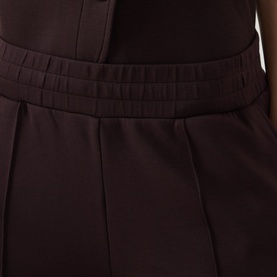 Varley Coffee Bean trousers close-up showing elasticated waistband and pleated wide-leg silhouette in viscose blend fabric
