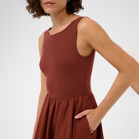 Model wearing Kaffe henna sleeveless dress with fitted bodice, flared skirt and side pocket detail